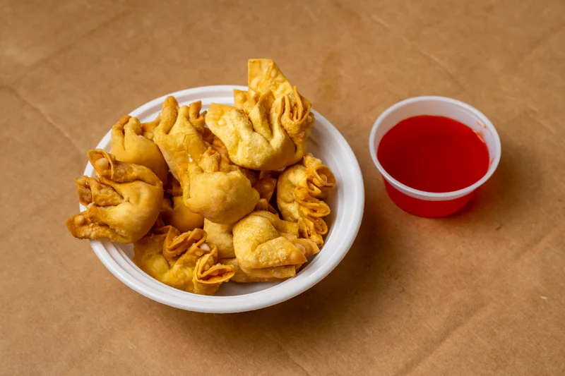 Crab Rangoon — crabmeat and cream cheese in a crisp fried wonton